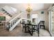 Charming dining area with glass table and four chairs, showcasing staircase at 6250 Holmes Blvd # 71, Holmes Beach, FL 34217