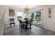 Bright dining area with glass table and four chairs, near sliding doors at 6250 Holmes Blvd # 71, Holmes Beach, FL 34217