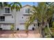 Two-story house with double garage and palm trees at 6250 Holmes Blvd # 71, Holmes Beach, FL 34217