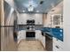 Modern kitchen with stainless steel appliances and blue countertops at 6250 Holmes Blvd # 71, Holmes Beach, FL 34217