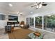 Open living area with sliding doors, large TV, and two comfy armchairs at 6250 Holmes Blvd # 71, Holmes Beach, FL 34217
