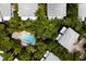 Community pool with lounge chairs surrounded by lush tropical landscaping at 6250 Holmes Blvd # 71, Holmes Beach, FL 34217