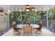 Relaxing screened porch with outdoor dining set and lush landscaping at 6250 Holmes Blvd # 71, Holmes Beach, FL 34217