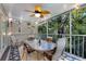 Relaxing screened porch with outdoor dining set and lush landscaping at 6250 Holmes Blvd # 71, Holmes Beach, FL 34217