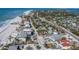 Beautiful aerial view of a home with a pool, near the beach, and surrounded by tropical greenery at 6473 Gulf Of Mexico Dr, Longboat Key, FL 34228