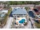 Aerial view of the backyard with a uniquely shaped pool, patio furniture, and well-maintained landscaping at 6473 Gulf Of Mexico Dr, Longboat Key, FL 34228