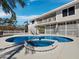 Inviting backyard featuring a kidney-shaped pool with an attached spa and upper level outdoor access at 6473 Gulf Of Mexico Dr, Longboat Key, FL 34228