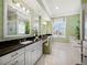 Bright bathroom featuring dual sinks, granite countertops, and ample natural light at 6473 Gulf Of Mexico Dr, Longboat Key, FL 34228