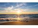 Golden sunset over the ocean waves gently lapping the sandy beach at 6473 Gulf Of Mexico Dr, Longboat Key, FL 34228