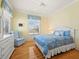 Comfortable bedroom with blue accents, hardwood floors, and plenty of natural light at 6473 Gulf Of Mexico Dr, Longboat Key, FL 34228