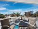 Outdoor lanai offers comfortable seating and a peek at the ocean at 6473 Gulf Of Mexico Dr, Longboat Key, FL 34228