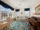 Versatile living room with a piano, large windows with nice curtains, and a comfortable sofa at 6473 Gulf Of Mexico Dr, Longboat Key, FL 34228