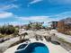 Relaxing pool area showcasing lounge chairs and outdoor dining set surrounded by tropical landscaping and nearby homes at 6473 Gulf Of Mexico Dr, Longboat Key, FL 34228