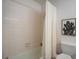 Simple bathroom with shower/tub, toilet and off-white tile at 6884 W Country Club Ln, Sarasota, FL 34243