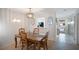 Dining room with wooden table and chairs, view to kitchen at 6884 W Country Club Ln, Sarasota, FL 34243