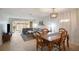 Open concept living and dining area with tile floors, a large sectional sofa, and a wooden dining table at 6884 W Country Club Ln, Sarasota, FL 34243