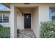 Home's entrance with black door and brick walkway at 6884 W Country Club Ln, Sarasota, FL 34243