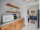 Kitchen with wood cabinets, granite counters, and microwave at 6884 W Country Club Ln, Sarasota, FL 34243