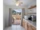 Kitchen with patio access and light wood cabinets at 6884 W Country Club Ln, Sarasota, FL 34243