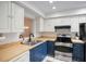 Updated kitchen with blue cabinets and stainless steel appliances at 6884 W Country Club Ln, Sarasota, FL 34243
