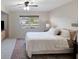 Bright main bedroom with a queen bed, window, and neutral decor at 6884 W Country Club Ln, Sarasota, FL 34243