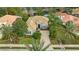 Luxury home with tile roof, driveway, and lush landscaping, in a golf course community at 7019 Vilamoura Pl, Lakewood Ranch, FL 34202