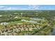 Aerial view of upscale houses surrounding a golf course and lakes at 7019 Vilamoura Pl, Lakewood Ranch, FL 34202