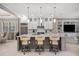 Modern kitchen with white cabinets, granite island, and globe pendant lights at 7019 Vilamoura Pl, Lakewood Ranch, FL 34202