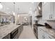 Modern kitchen with stainless steel appliances and a large island at 7019 Vilamoura Pl, Lakewood Ranch, FL 34202