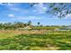 Backyard view of a pond with golf course and homes in the background at 7317 Ballantrae Pl # 27B, Sarasota, FL 34238