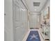 Bright entryway with coat closets and decorative star rug at 7317 Ballantrae Pl # 27B, Sarasota, FL 34238