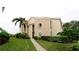 Exterior of condo building showing landscaped grounds and walkway at 8644 54Th W Ave # 8644, Bradenton, FL 34210