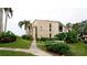 Condo building exterior with landscaping and walkway leading to entrance at 8644 54Th W Ave # 8644, Bradenton, FL 34210