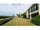 Exterior view of condo building with waterfront access and lush landscaping at 8644 54Th W Ave # 8644, Bradenton, FL 34210