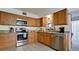 Kitchen boasts stainless steel appliances and wood cabinets at 8644 54Th W Ave # 8644, Bradenton, FL 34210