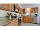 Kitchen with wood cabinets, granite counters, and stainless steel appliances at 8644 54Th W Ave # 8644, Bradenton, FL 34210