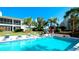 Inviting community pool with lounge chairs and palm trees at 8644 54Th W Ave # 8644, Bradenton, FL 34210