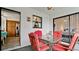 Screened porch with red chairs and a small table at 8644 54Th W Ave # 8644, Bradenton, FL 34210