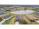 Community view showcasing a tranquil pond and houses at 10605 58Th E St, Parrish, FL 34219