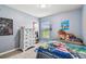 Playful bedroom with a twin bed, lion plushie, and Mario Kart bedding at 10605 58Th E St, Parrish, FL 34219