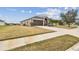 Single-story house with brown garage door and driveway at 10605 58Th E St, Parrish, FL 34219