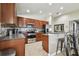 Updated kitchen with stainless steel appliances, dark wood cabinets, and an island at 10605 58Th E St, Parrish, FL 34219