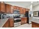 Well-equipped kitchen featuring stainless steel appliances and dark wood cabinets at 10605 58Th E St, Parrish, FL 34219