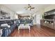 Living room with sectional sofa, large TV and hardwood floors at 10605 58Th E St, Parrish, FL 34219