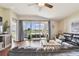 Relaxing living room with leather sectional sofa and view of the backyard and lake at 10605 58Th E St, Parrish, FL 34219