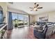 Bright living room featuring hardwood floors, sliding glass doors, and a view of a lake at 10605 58Th E St, Parrish, FL 34219
