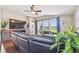 Living area showcasing hardwood floors, large TV, and access to a patio overlooking a lake at 10605 58Th E St, Parrish, FL 34219