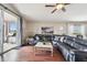 Spacious living room with a large sectional sofa, wood floors, and sliding glass doors leading to a patio at 10605 58Th E St, Parrish, FL 34219