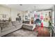 Spacious living room with hardwood floors, large sectional sofa, and home office area at 10605 58Th E St, Parrish, FL 34219