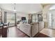 Bright living room featuring hardwood floors, a sectional sofa, and ample natural light at 10605 58Th E St, Parrish, FL 34219